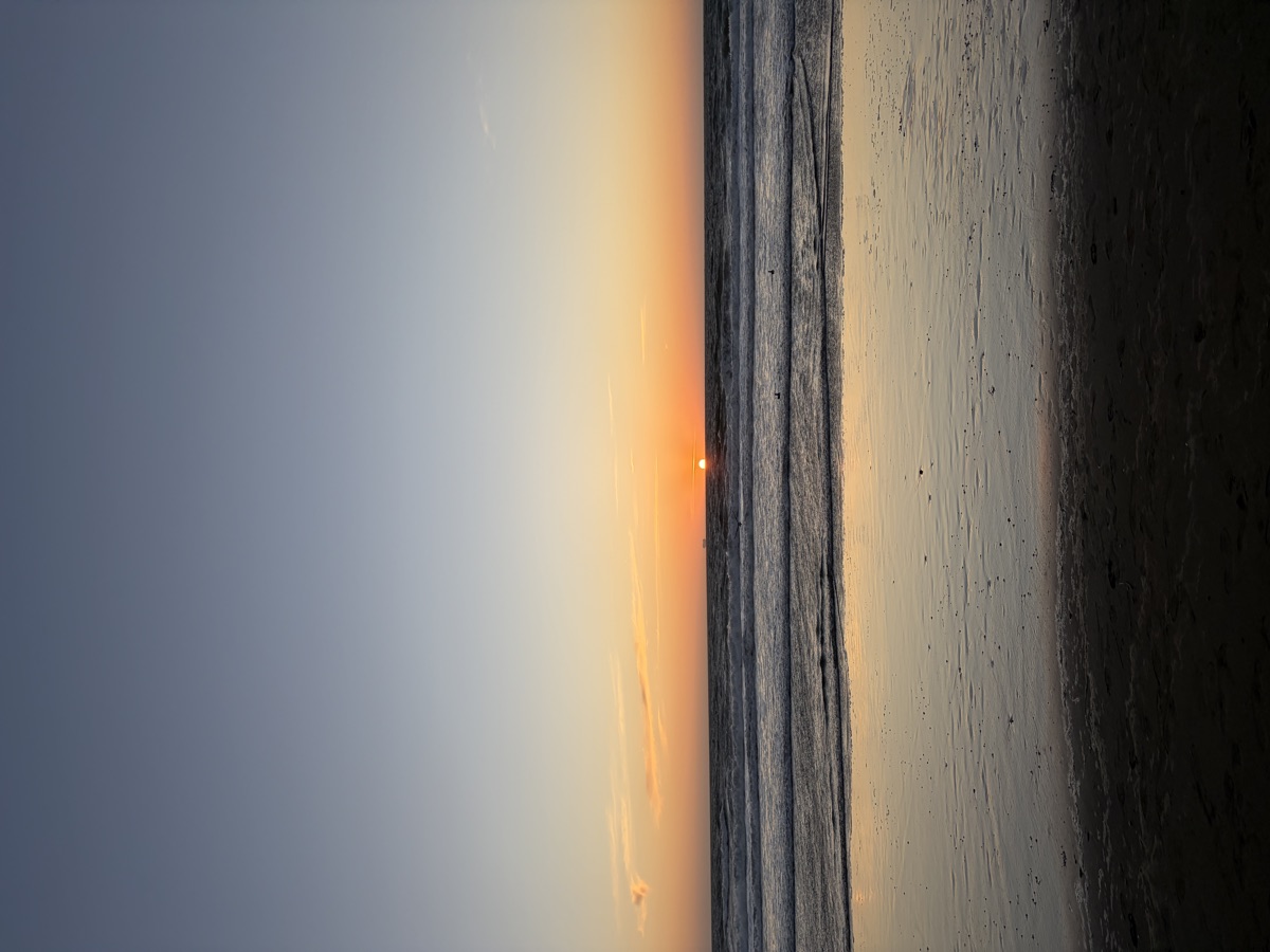 Sunset reflecting on the wet sand at Ocean Beach